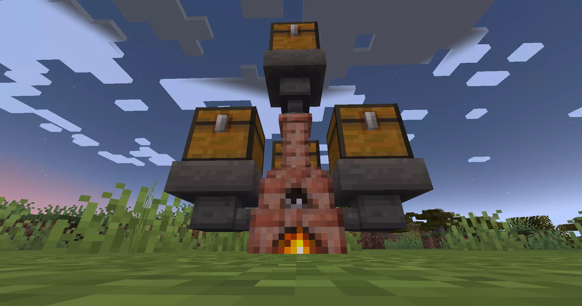 両脇と背面と上面にホッパーでチェストが接続され、炉内に火が付いており、草原に設置されたアタノールの様子