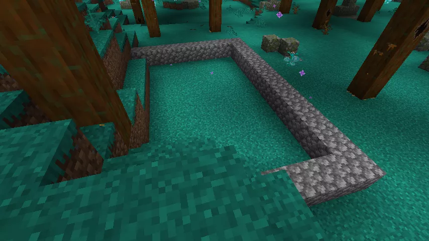 青緑色の草地にハイメヴィスカの大木が生える妖精の樹海、その斜面に丸石で3辺の外枠が置かれている様子