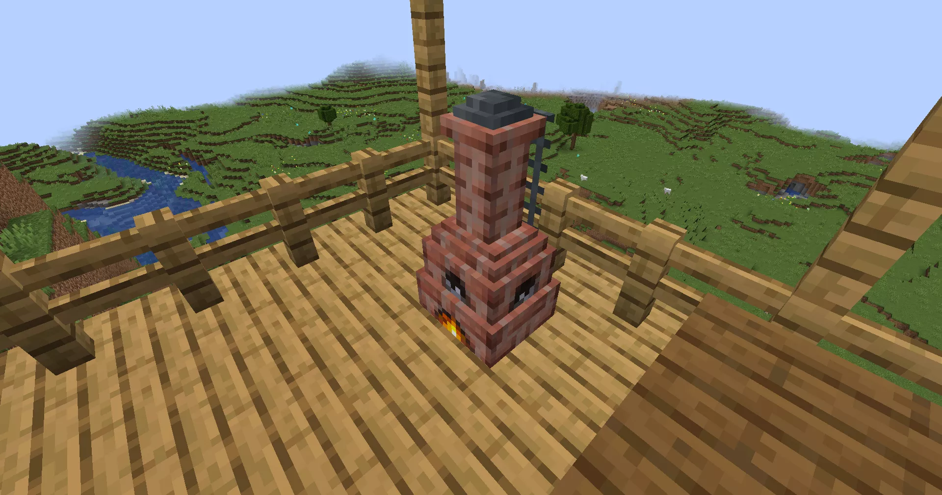 山の上のウッドデッキに設置され、炉内に火が付いているアタノールの様子