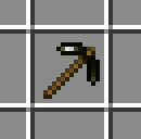 木の柄の先に光沢のある黒色のヘッドが付いた磁鉄鉱のつるはし