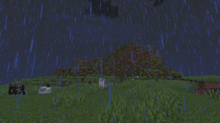 大雨の中、野生の牛や羊が見え、遠景に小さな山の見える、木が一本も無い薄暗い平原の様子